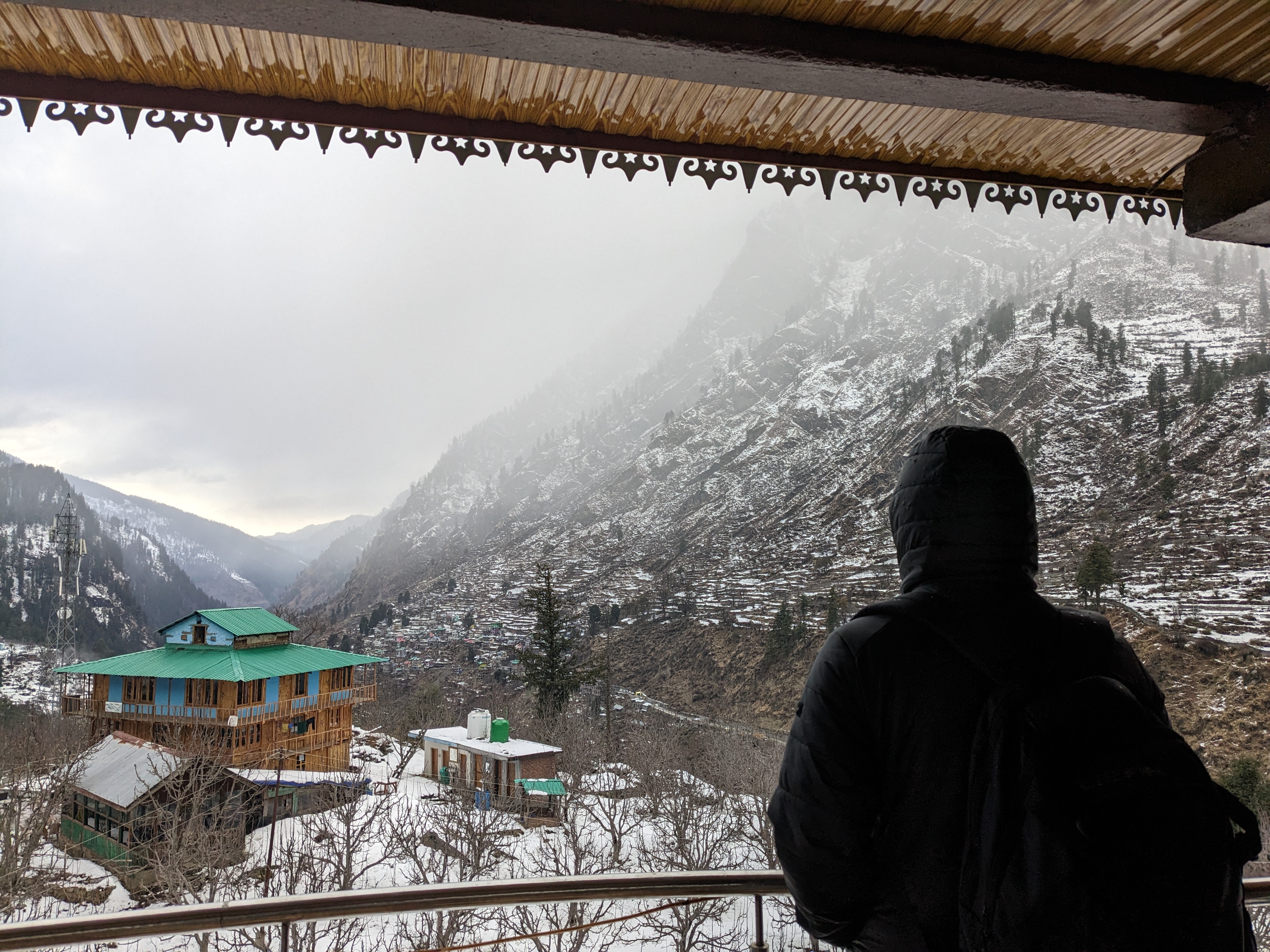 a person enjoying a snow capped hill view
